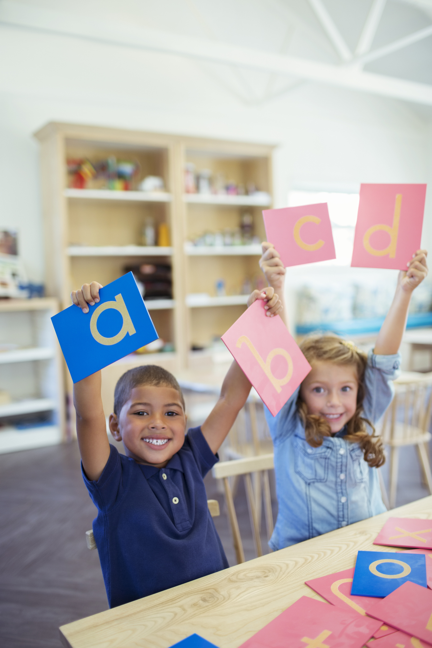 Students holding letters in classroom